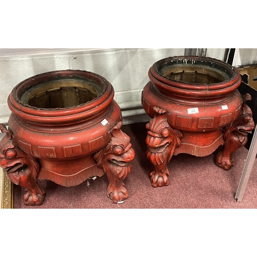 593 - Oriental: Early 20th century red painted treen, decorated with carved dragon heads on three supports... 