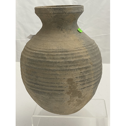 601 - Oriental: A burial jar with ribbed sides and flattened base, possibly Han Dynasty, 29cm high.... 