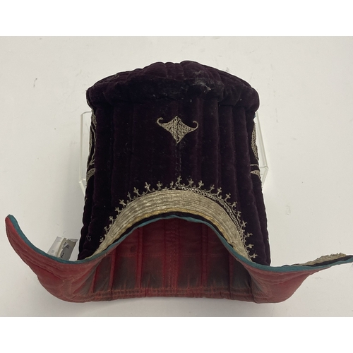 614 - Costume headgear: Costume 19th century Tibetan headgear. Thick quilting in shapen velvet with badges... 