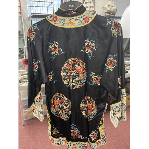 615 - Fashion: c1950s Chinese black silk long-sleeve jacket, heavily embroidered with panels.