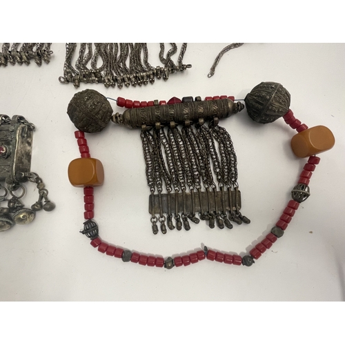 623 - Tribal Bedouin - Saudi: Box amulet and neck chain set with pink & red glass with five bells plus... 