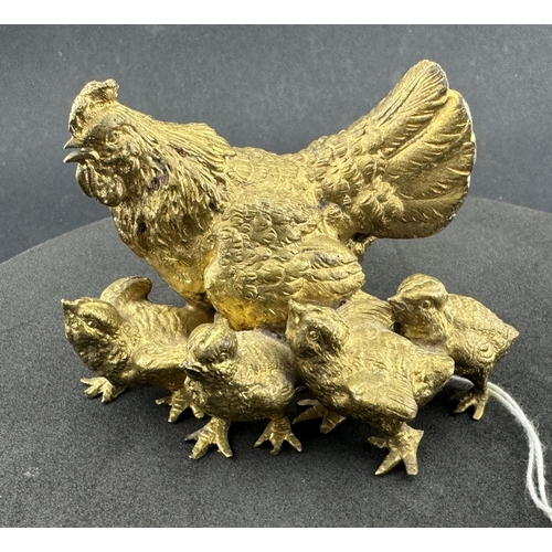 715 - Metalware: A gilt bronze group of a cockerel with four chicks, unmarked, 8cm long.