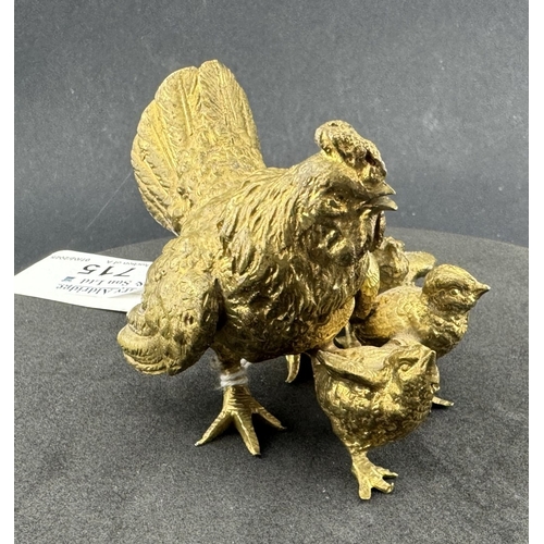 715 - Metalware: A gilt bronze group of a cockerel with four chicks, unmarked, 8cm long.