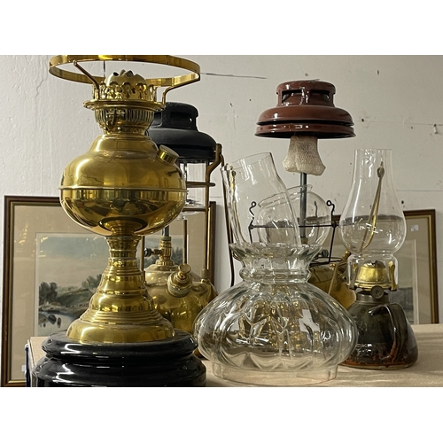 77 - Lighting: A box of 4 Edwardian oil lamps with clear glass-shaped shades, tallest 56cm mounted on a b... 