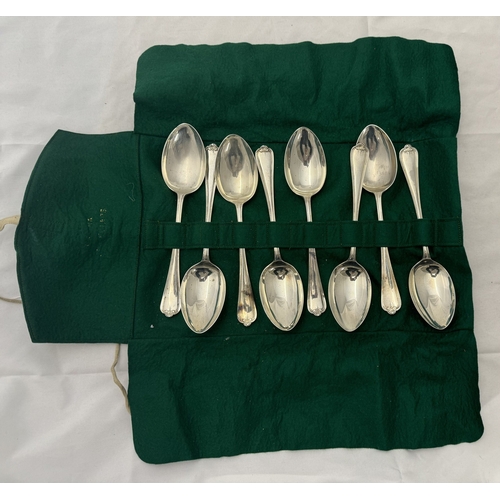 804 - Silver: A set of eight Jesmond pattern table spoons in a cutlery roll, Sheffield 1953-54, 21cm long,... 