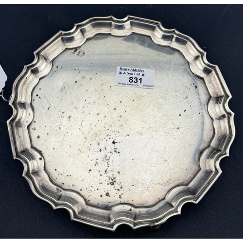 831 - Silver: A card tray by Mappin and Webb, Sheffield 1935, with pie crust rim and standing upon three h... 