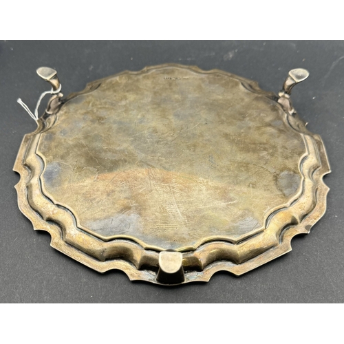 831 - Silver: A card tray by Mappin and Webb, Sheffield 1935, with pie crust rim and standing upon three h... 