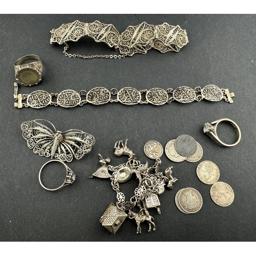 840 - Silver Jewellery: A charm bracelet, suspended with ten charms including a Nuvo opening cottage and a... 