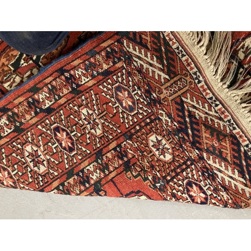 89 - Carpet/Rugs: Polygons in red-dark blue, and red-white both field and borders a deep red. 145 x 125cm... 