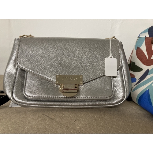 9 - Fashion: A Juno silver coloured leather handbag, together with outer slip bag: two similar multi col... 