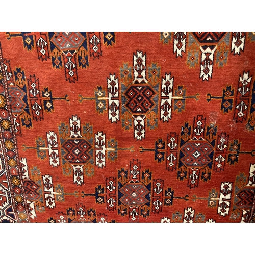 92 - Carpets/Rugs: Red ground afghan rug, hatched design with woven fringe.