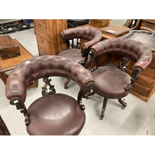 98 - Furniture: A group of three office chairs in mahogany, with button-upholstered faux leather seats on... 