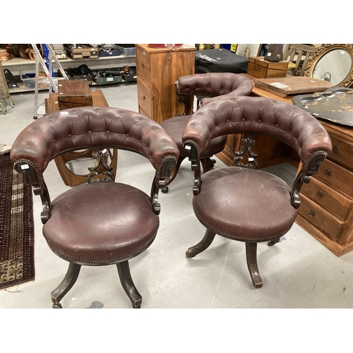 98 - Furniture: A group of three office chairs in mahogany, with button-upholstered faux leather seats on... 