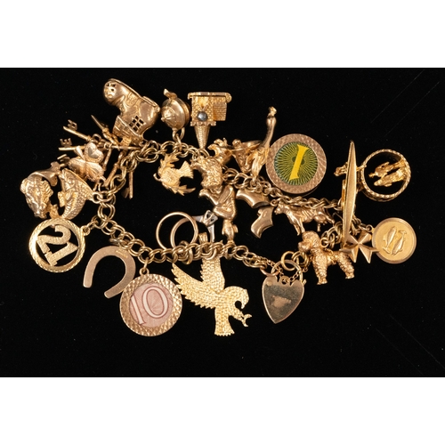 533 - Jewellery: a 9ct gold bracelet with heart shaped clasp, suspended with at least 24 charms including ... 