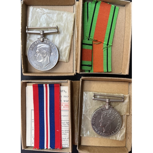 56 - A group of x5 UK WWII medals and coins, including x2 Defence Medals, France and Germany Star and x2 ... 