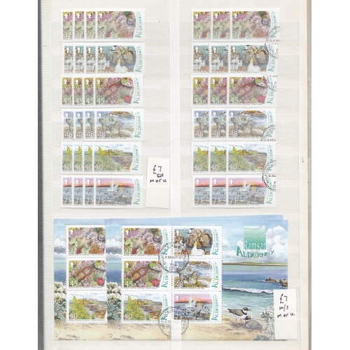 581 - An ex-dealers duplicated mint and used Alderney stamp stock in x2 volumes, from 1984 to 2010, includ... 