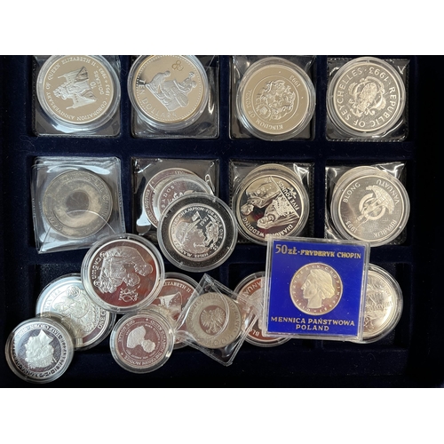 95 - A collection of x26 World silver coins, majority Crown size 1oz coins.