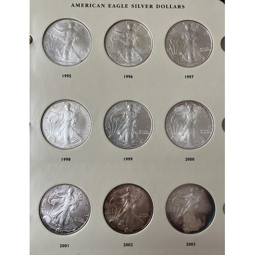 23 - A collection of x28 USA uncirculated silver $1 coins from 1986 to 2015 housed in a Littleton album i... 