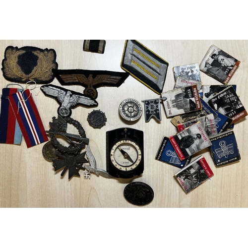 148 - A small group of German WWII related items including War Wound Badge, Cap Badges, Compass and miniat... 