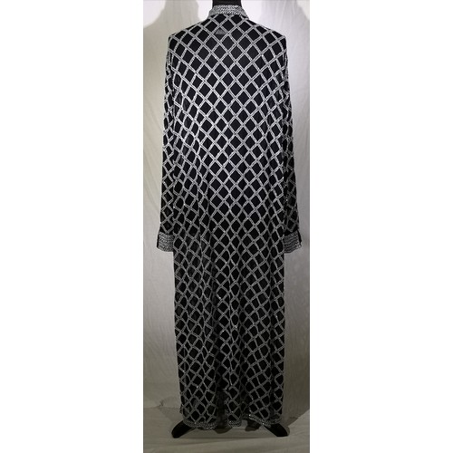 62 - White beads hand embroidered on black background. High neck, sheer long sleeves, relaxed fit jacket.... 
