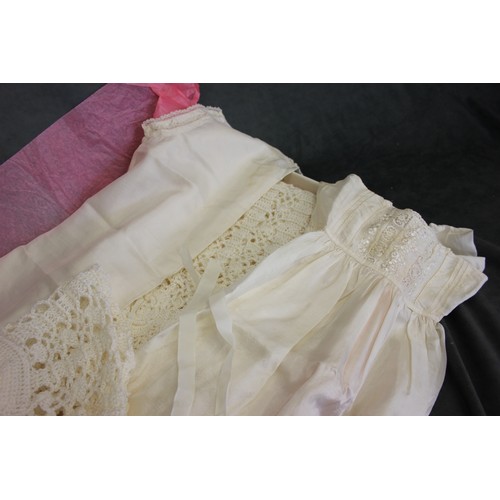 88 - Two satin Christening robes with embroidered decoration together with a crochet work robe, and a bon... 