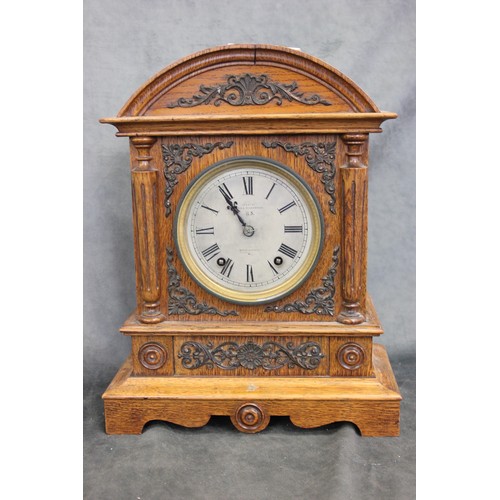 170 - A late Victorian oak mantel clock, with German striking movement, and silvered dial, 38cm high.