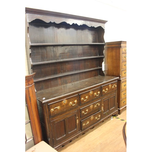 196 - An 18ct century stained oak dresser, with planked rack, the base fitted five drawers and two panelle... 