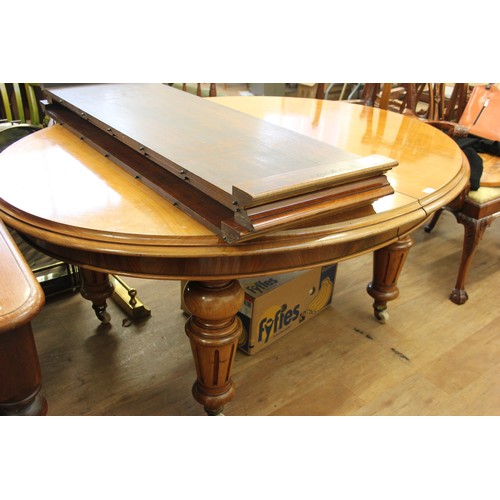 226 - A Victorian pale mahogany oval form dining table, with moulded edge, wind out action and three extra... 