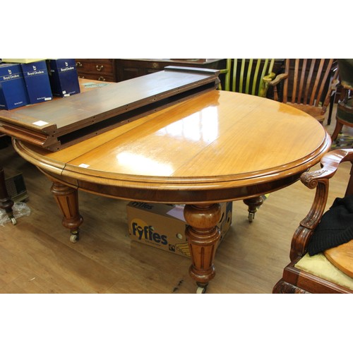 226 - A Victorian pale mahogany oval form dining table, with moulded edge, wind out action and three extra... 