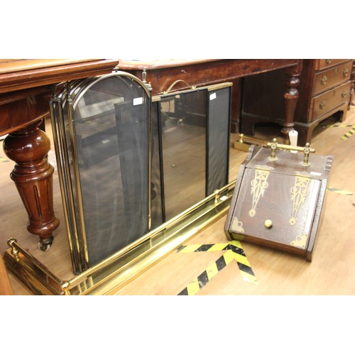 228 - A brass fender 179cm wide, a late Victorian oak and brass coal scuttle, and two modern fireguards (4... 