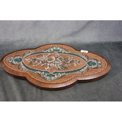 229 - A Victorian rosewood wall plaque, with petit point decoration, of shaped outline, 57cm wide.