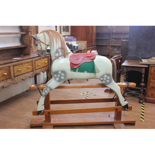 3 - A wooden rocking horse of Haddon Rockers style, on pale wooden trestle base, with steel tubular rock... 