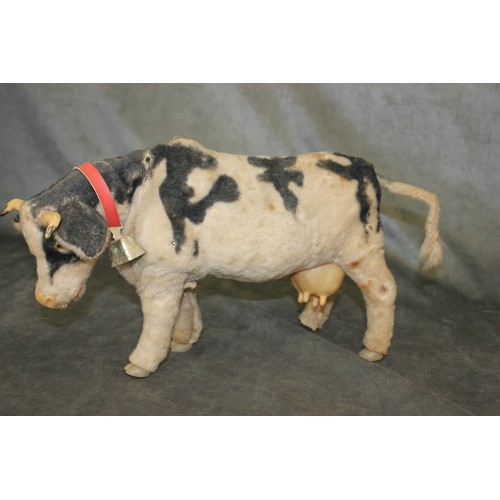 6 - A Japanese felt covered toy cow, with push button mechanism, 32cm long a.f.