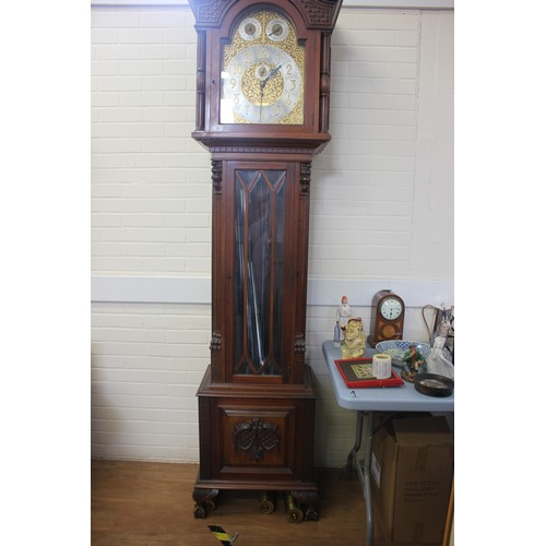 48 - A large Edwardian mahogany longcase clock with carved decoration, three train movement, striking on ... 