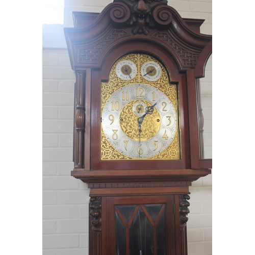 48 - A large Edwardian mahogany longcase clock with carved decoration, three train movement, striking on ... 