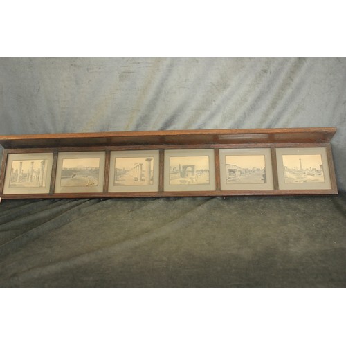 149 - An early 20th century oak hanging shelf, with six framed photographs of Roman amphitheatre and ruins... 