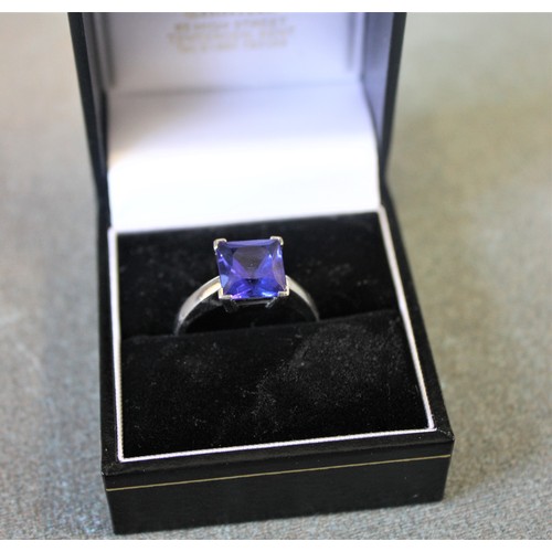 55 - An 18ct white gold dress ring, set a square tanzanite approx. 3.79 carats, with South African EGL ce... 