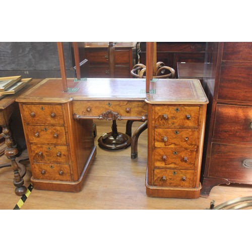 241 - A Victorian walnut kneehole desk, inverted breakfront outline, fitted nine drawers, with knob handle... 