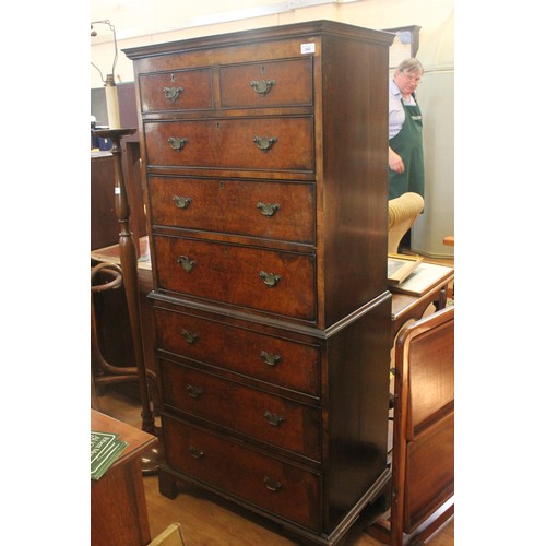 242 - An early 20th century walnut veneered and simulated walnut chest on chest of two short and six long ... 