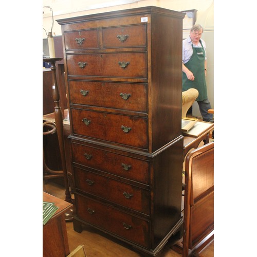 242 - An early 20th century walnut veneered and simulated walnut chest on chest of two short and six long ... 