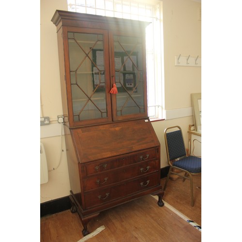 243 - An early 20th century Georgian style mahogany bureau bookcase, the upper part enclosed by astragal g... 