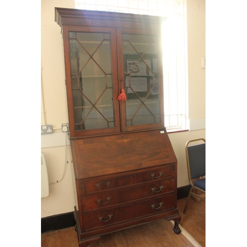 243 - An early 20th century Georgian style mahogany bureau bookcase, the upper part enclosed by astragal g... 