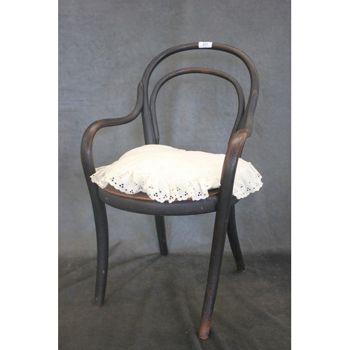 311 - A child size ebonised bent wood chair, with cushion.