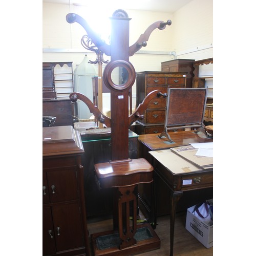 285 - A Victorian mahogany hall stand, with four branches, fitted turned hooks, and circular mirror, glove... 