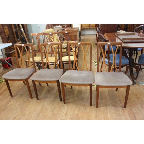 192 - A set of four G-Plan teak dining chairs, with curved slatted backs, pad seats, on square tapering le... 