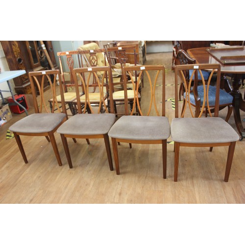 192 - A set of four G-Plan teak dining chairs, with curved slatted backs, pad seats, on square tapering le... 