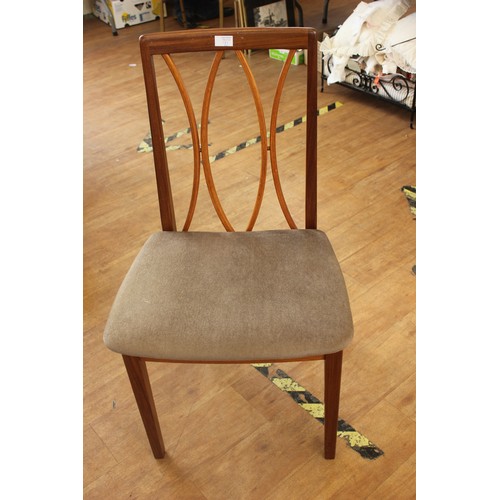 192 - A set of four G-Plan teak dining chairs, with curved slatted backs, pad seats, on square tapering le... 