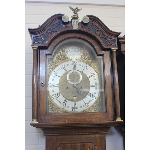 8 - A 19th century oak longcase clock with arched and carved hood and brass finial, the eight-day moveme... 