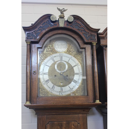 8 - A 19th century oak longcase clock with arched and carved hood and brass finial, the eight-day moveme... 