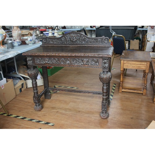 269 - A late 19th century carved and stained oak side or hall table, in the Flemish revival style, on heav... 